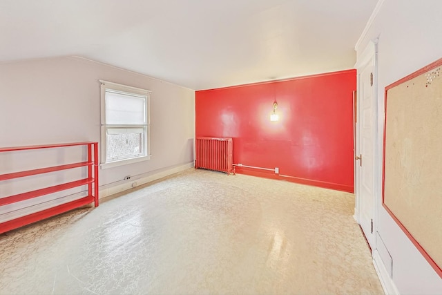 empty room with lofted ceiling and radiator heating unit