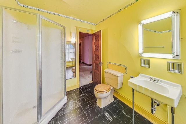 bathroom with toilet and walk in shower