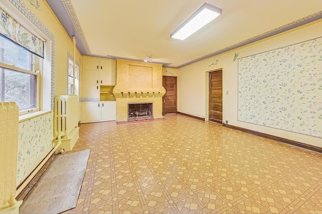 unfurnished living room with ornamental molding, built in features, and a fireplace