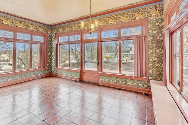 unfurnished sunroom featuring an inviting chandelier