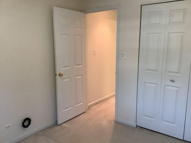 unfurnished bedroom with light carpet