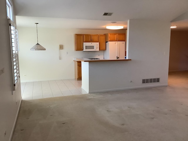 kitchen featuring light colored carpet, white appliances, kitchen peninsula, and hanging light fixtures