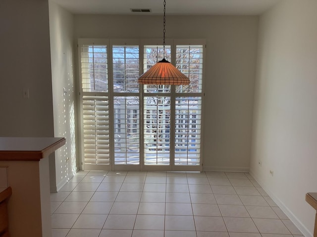 unfurnished dining area with a wealth of natural light and light tile patterned flooring