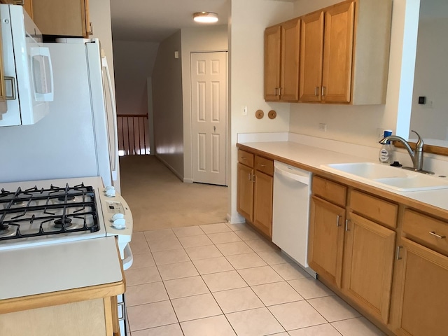 kitchen featuring sink, white appliances, and light carpet