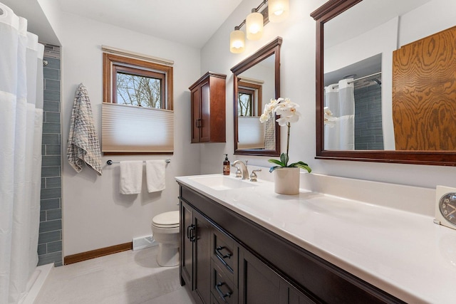 bathroom featuring vanity, toilet, and curtained shower