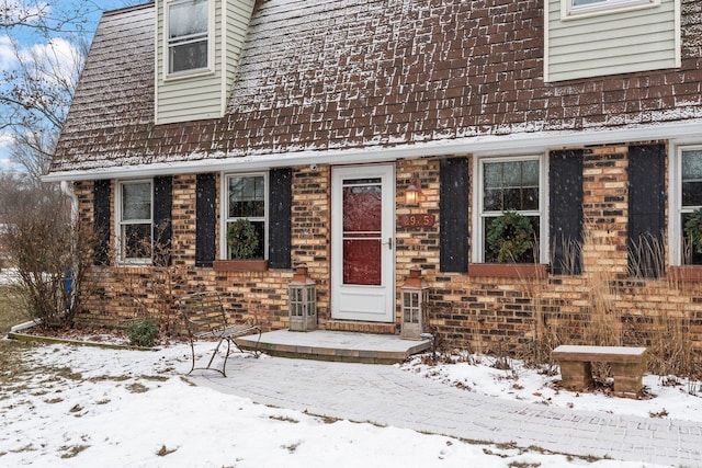 view of snow covered property entrance