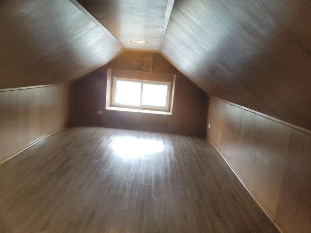 bonus room featuring vaulted ceiling and dark hardwood / wood-style floors