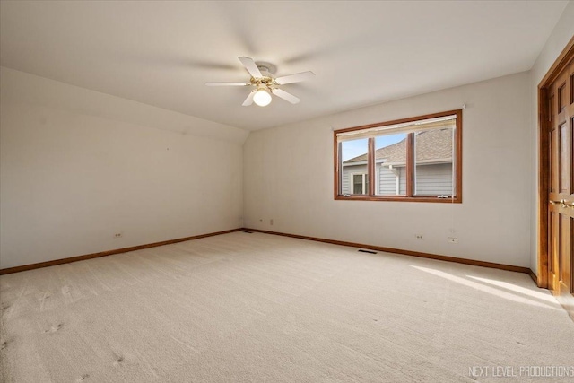 spare room featuring light carpet, baseboards, visible vents, and ceiling fan