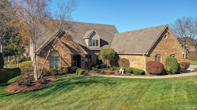 view of front facade with a front lawn and brick siding