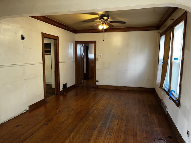 unfurnished room with crown molding, ceiling fan, and dark hardwood / wood-style flooring