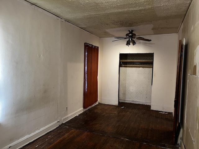 unfurnished bedroom featuring dark wood-type flooring and ceiling fan