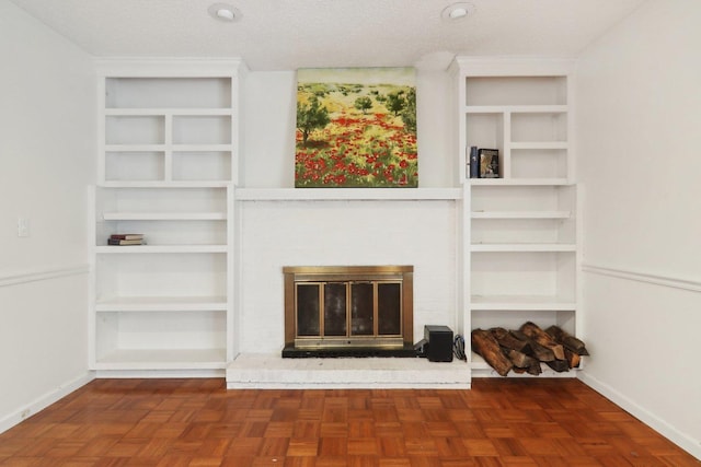 unfurnished living room featuring a fireplace and a textured ceiling