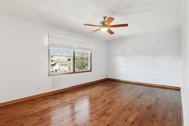 empty room featuring hardwood / wood-style floors, a textured ceiling, and ceiling fan