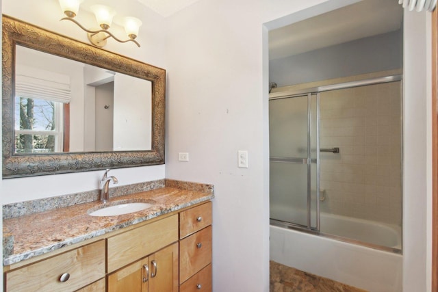 bathroom with vanity and combined bath / shower with glass door