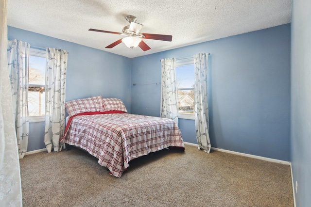 carpeted bedroom featuring a textured ceiling and ceiling fan