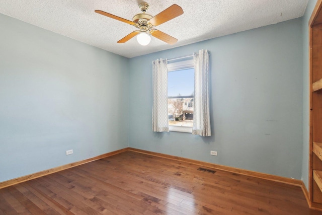 unfurnished room featuring ceiling fan, hardwood / wood-style flooring, and a textured ceiling