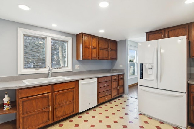 kitchen with sink, a wealth of natural light, and white appliances