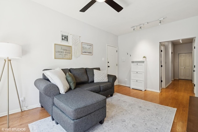 living room with wood-type flooring and ceiling fan