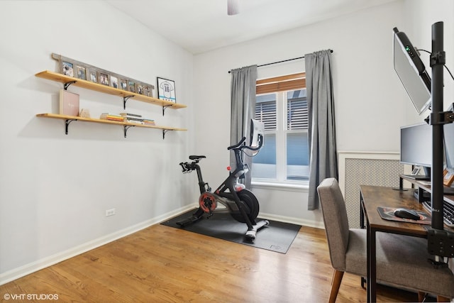 exercise room with hardwood / wood-style flooring and ceiling fan