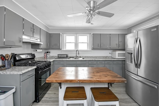 kitchen with stainless steel fridge with ice dispenser, black range with gas stovetop, and gray cabinets