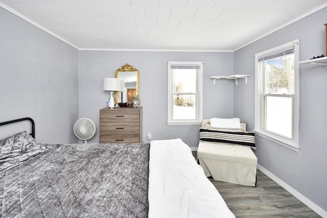 bedroom with multiple windows, crown molding, and dark wood-type flooring