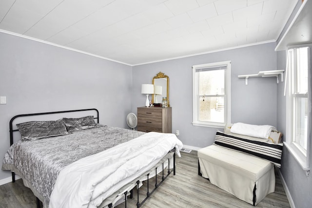 bedroom with crown molding and hardwood / wood-style flooring