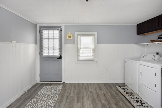 washroom featuring separate washer and dryer, hardwood / wood-style floors, ornamental molding, and a healthy amount of sunlight