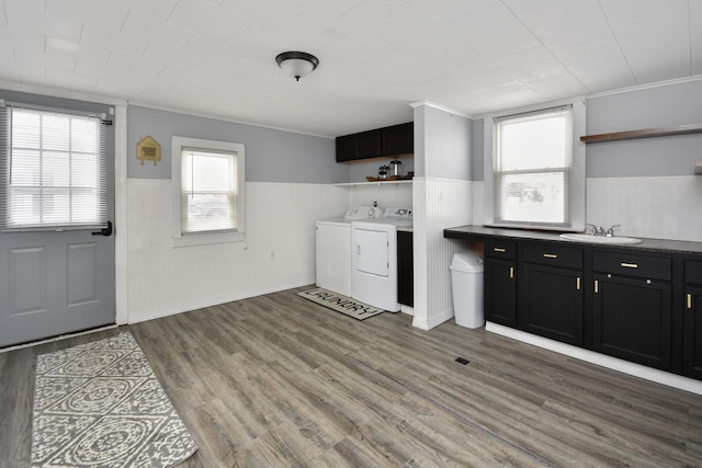 kitchen with plenty of natural light, sink, hardwood / wood-style floors, and washing machine and clothes dryer