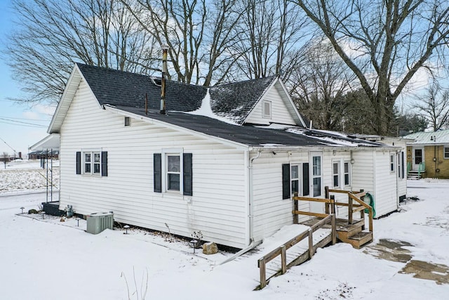 snow covered property featuring cooling unit