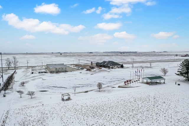 snowy yard featuring a rural view