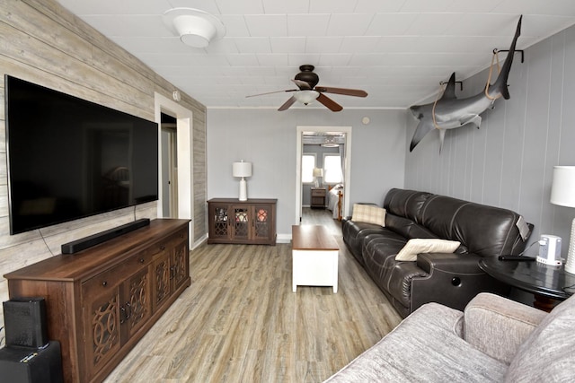 living room with ceiling fan and light hardwood / wood-style flooring