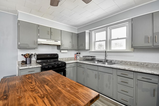 kitchen featuring sink, gray cabinets, and gas stove