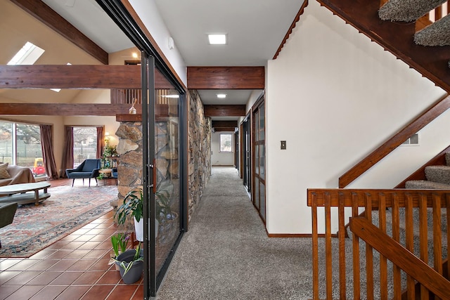 corridor featuring tile patterned flooring and vaulted ceiling with beams