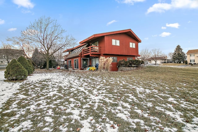 snow covered property with a yard