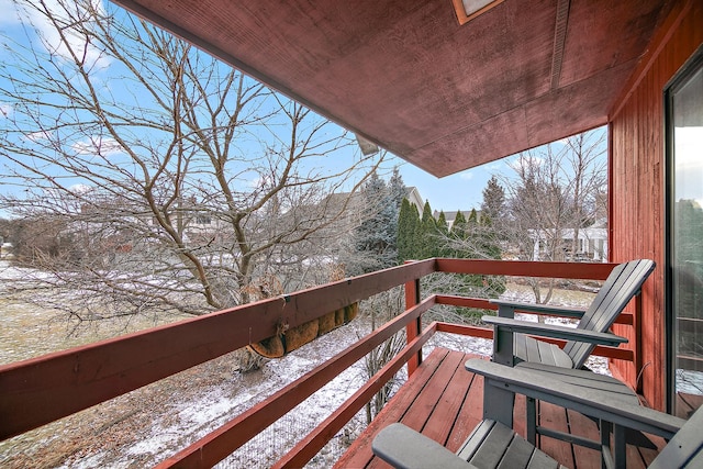 view of snow covered back of property