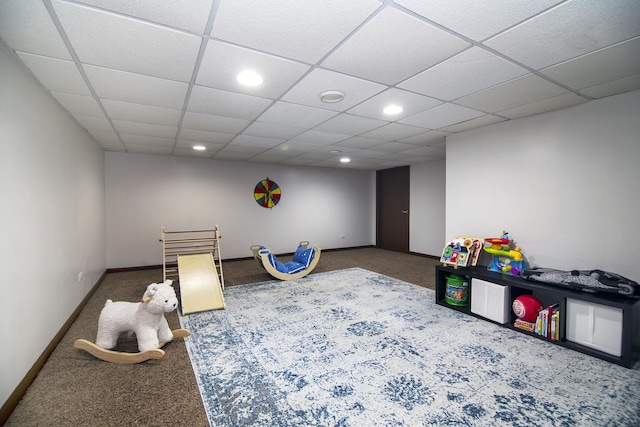 recreation room with carpet floors and a drop ceiling