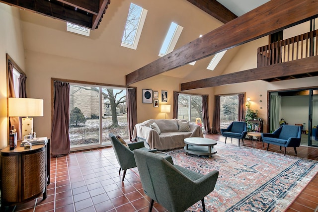 tiled living room with a healthy amount of sunlight, beam ceiling, a skylight, and high vaulted ceiling