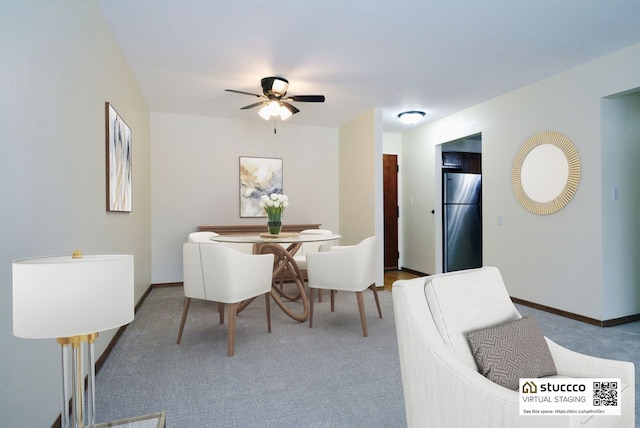 carpeted dining space featuring ceiling fan