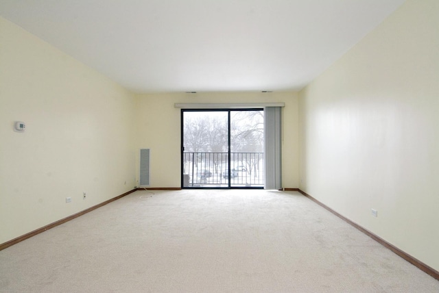 unfurnished room featuring light carpet