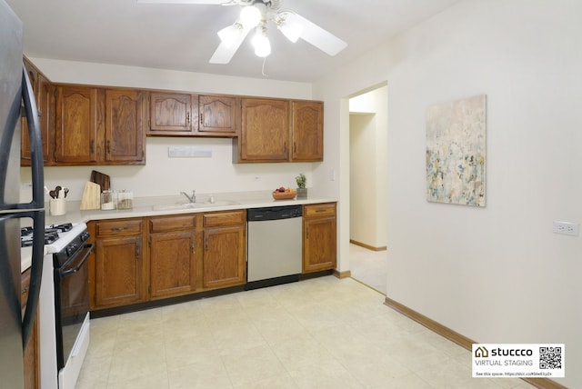 kitchen featuring ceiling fan, stainless steel appliances, and sink