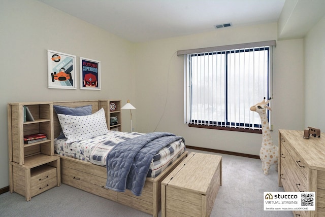 bedroom featuring light colored carpet