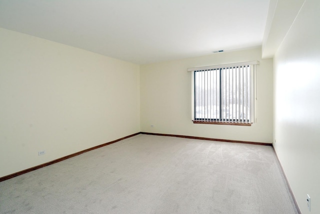 unfurnished room with light carpet