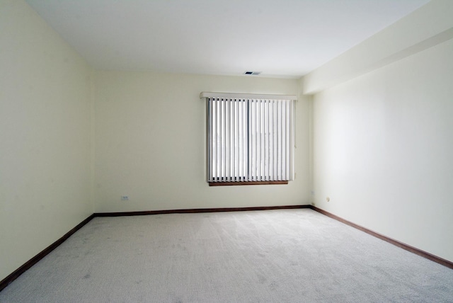 unfurnished room featuring light carpet