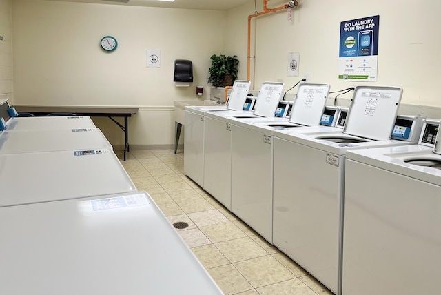 laundry area with washing machine and dryer and light tile patterned flooring