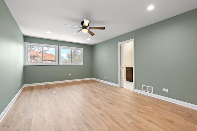 empty room featuring ceiling fan and light hardwood / wood-style floors