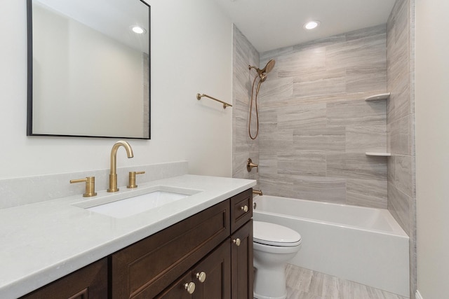 full bathroom with tiled shower / bath combo, vanity, and toilet