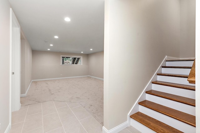 stairway featuring carpet flooring