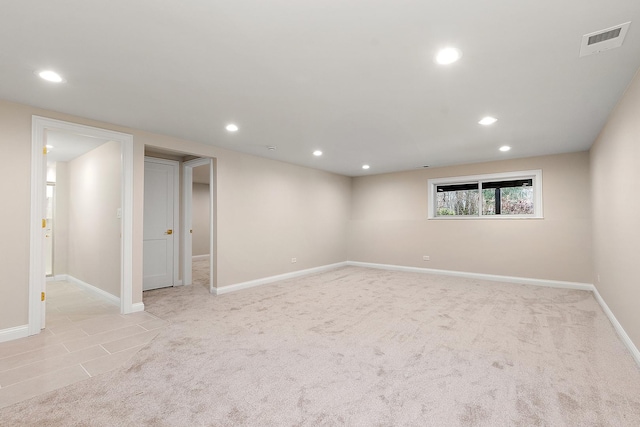 basement featuring light colored carpet