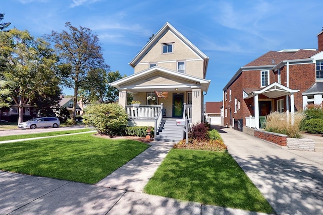 view of front of house with a porch, a garage, and a front yard