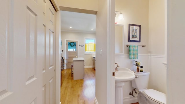 bathroom featuring hardwood / wood-style floors and toilet